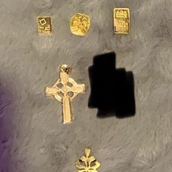 Two 1 gram 24k gold/ A half gram of 24k gold/ 14 k Celtic Cross/ 14k clover 