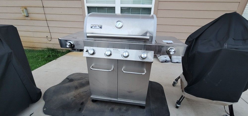 Monument Grills 4-Burner Propane Gas Grill in Stainless with Clear View Lid, LED Controls, Side and Sear Burners