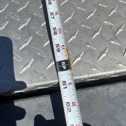 This is a durable, aluminum diamond plate truck tool box designed for secure storage in the bed of a