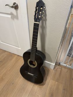 Caraya black classical nylon-string guitar — one broken string
