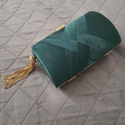 Emerald green clutch bag  with golden accents.
