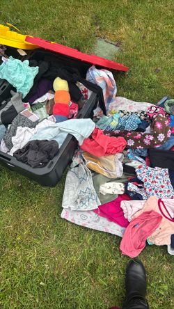 Two yellow top bins full of children’s clothes. Great for reselling