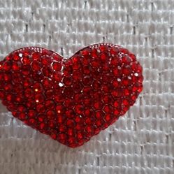 Red heart-shaped rhinestone brooch.