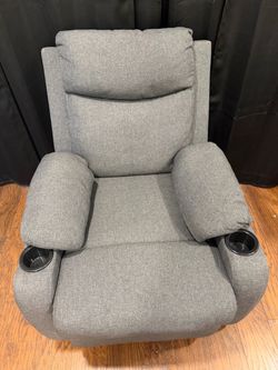 Gray recliner with cup holders.