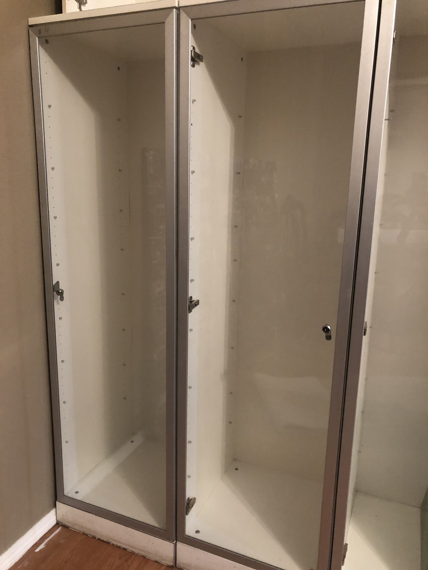 Tall white cabinets with glass door and glass shelves $100 each Total 3 cabinets
