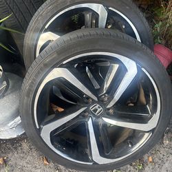 Three Honda accord rims with tire