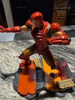 2 Action Figures 1 Iron man statue and Piggy bank Spiderwomen