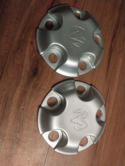Genuine OEM Dodge Ram 1500 Wheel Center Cap in a painted silver finish,