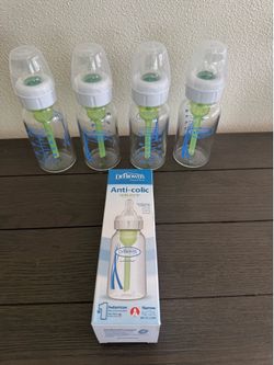 4-Dr. Brown’s glass baby bottles and 1 new plastic bottle
