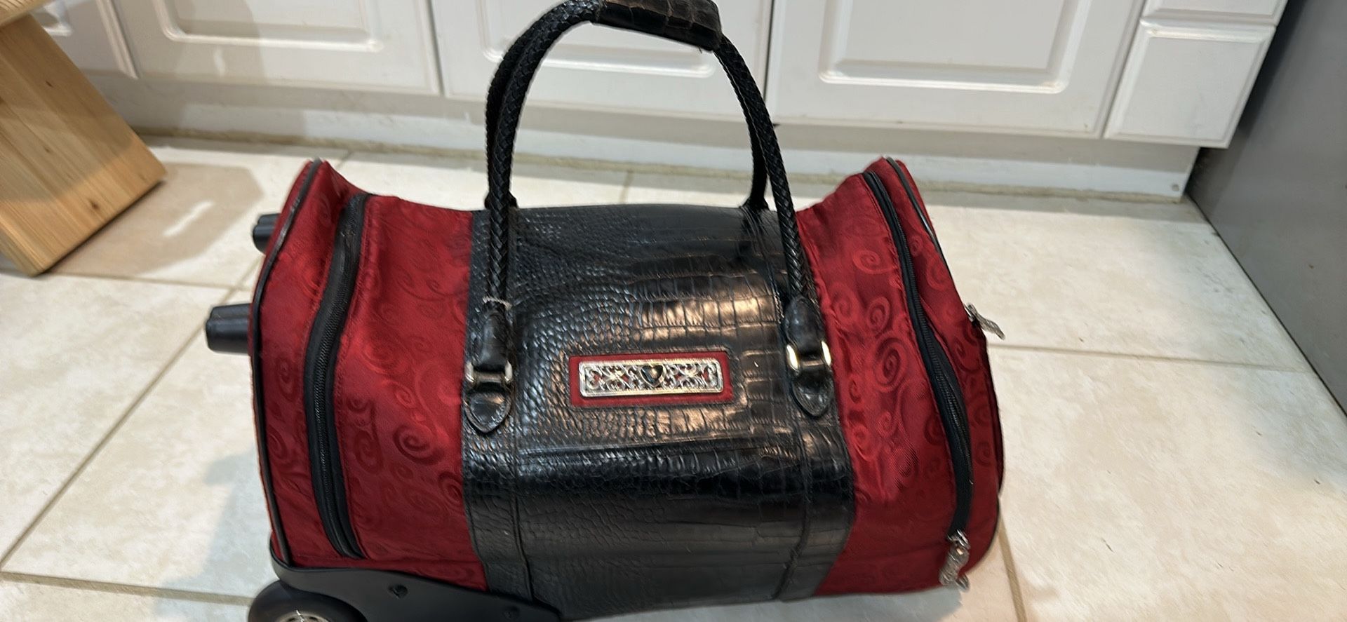 Luggage Brighton Rolling Duffel Weekender Red and Black. Leather and Canvas. 21 “ x 10” x 12”