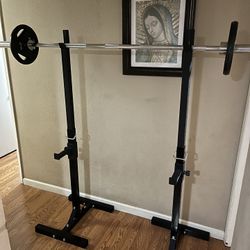 Stand rack & barbell 7ft and two cap plates 25 pounds each like new