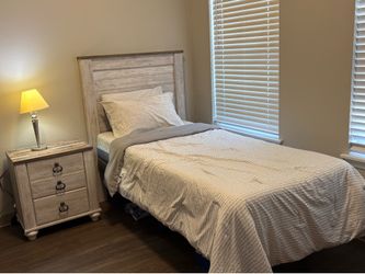Twin bed with adjustable head and foot position. Wood grain headboard and nightstand included.