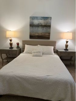 Queen mattress with upholstered headboard.