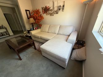 Beige sectional with reversible chaise lounger