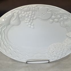 A large white ceramic platter with raised fruit designs by A. Santos Portugal. 19.5”x 14”