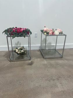 A pair of chrome and glass table