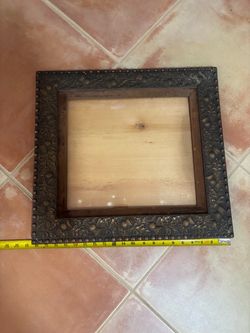 Antique dark wood frame with embossed decorative border