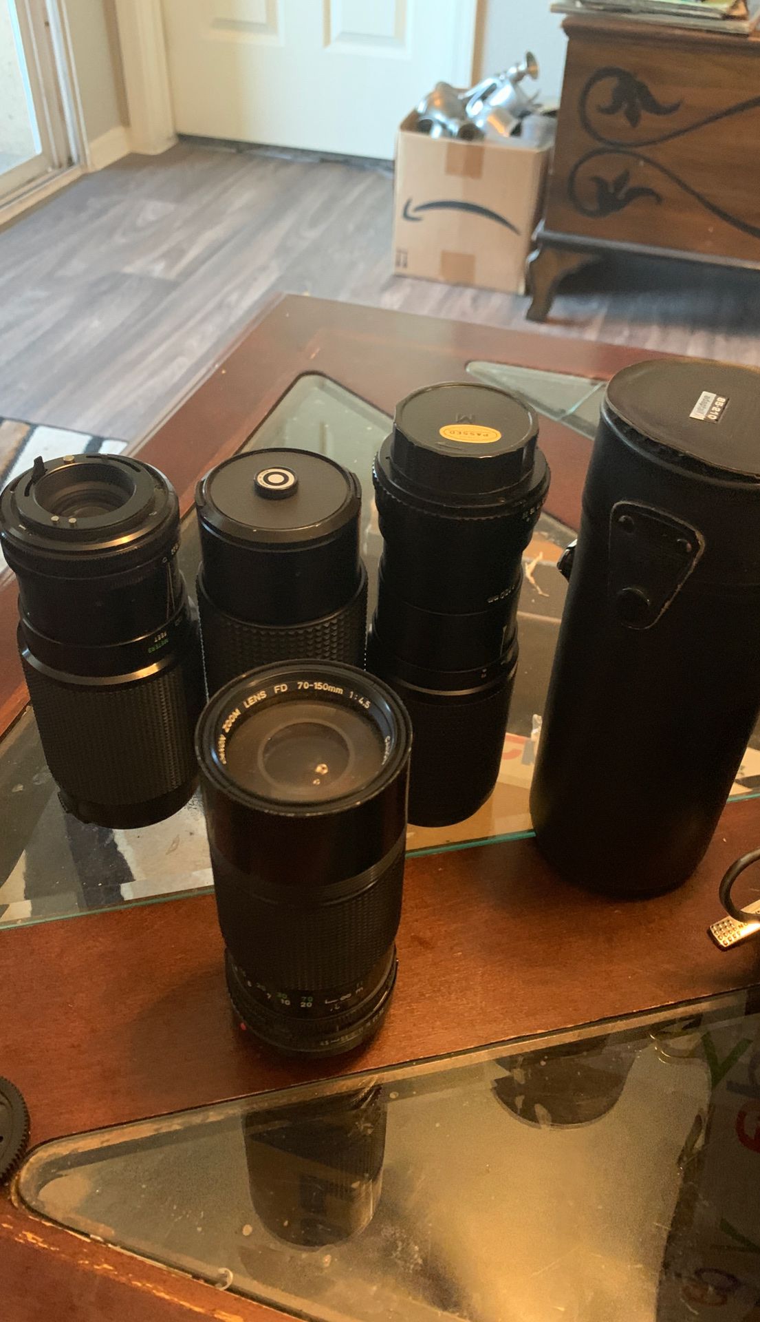 5 camera lenses, 2 bags, an old Petri camera, a flash, and other various attachments.
