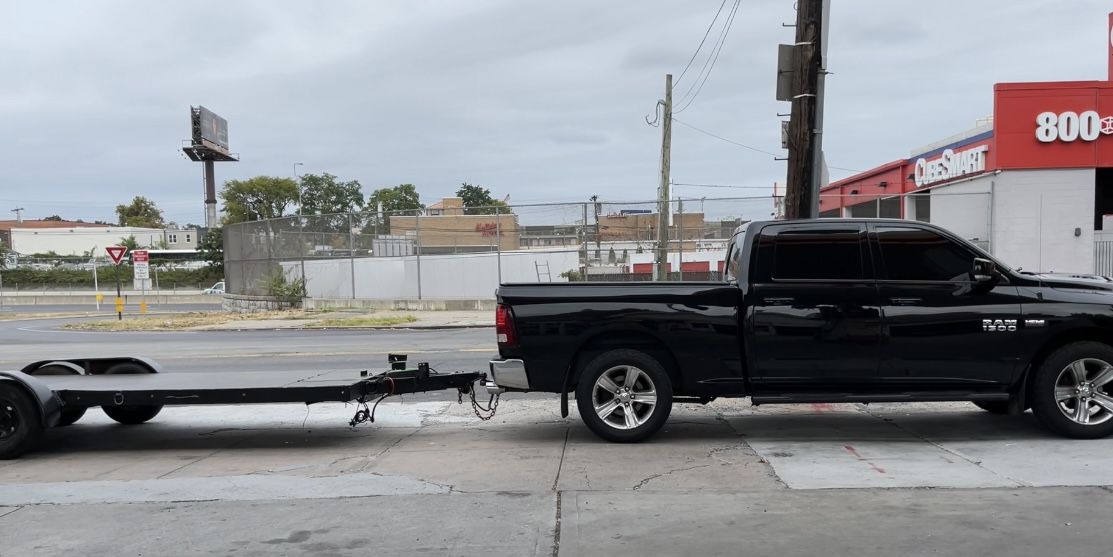 Black Dodge Ram With Car Trailer