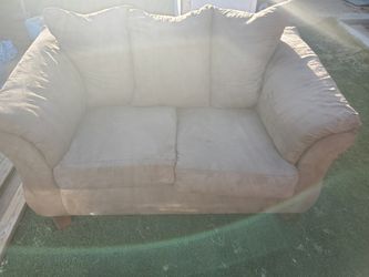 Ashley loveseat tan in color
