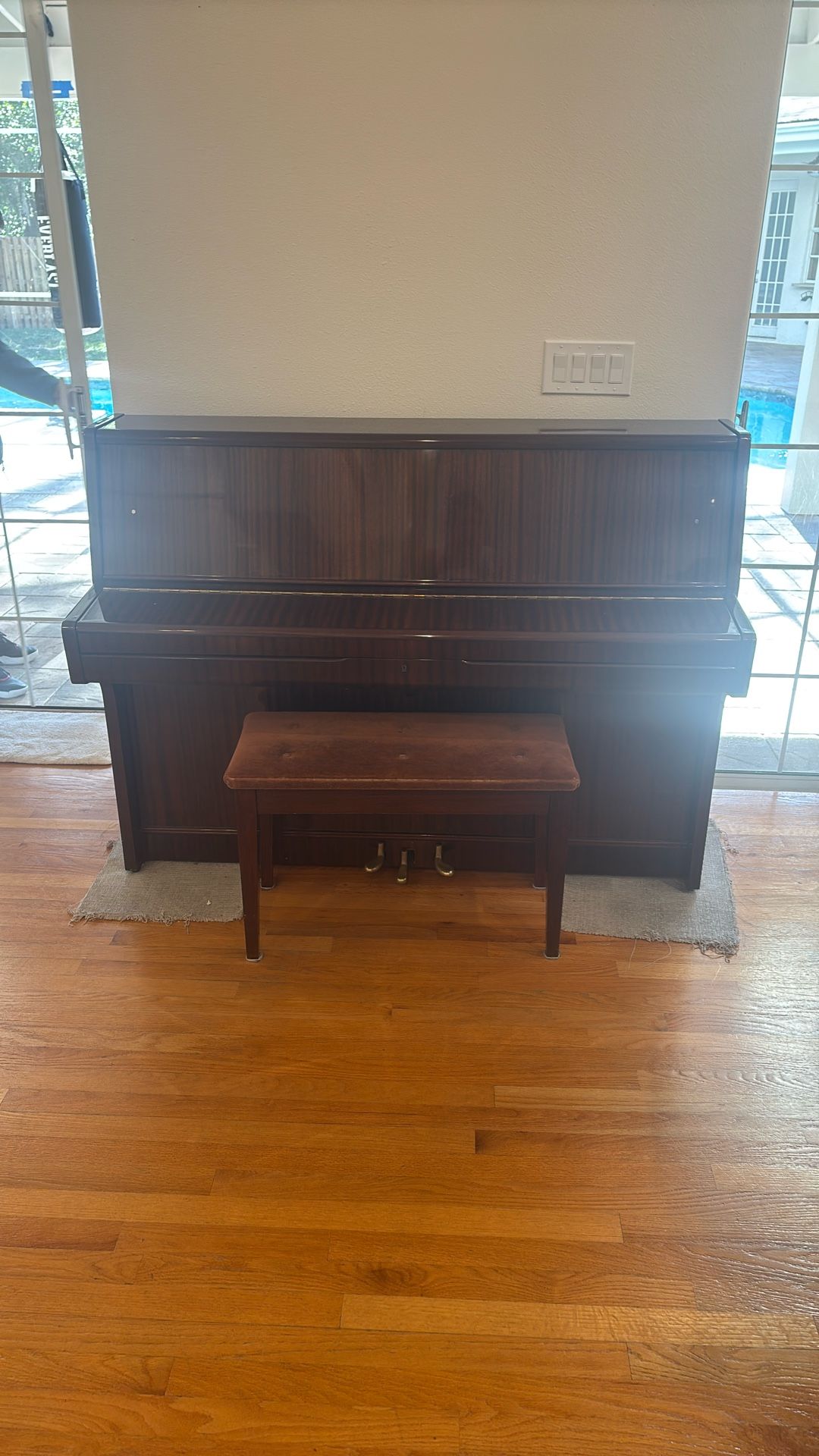 Hohner HP110 upright piano with a matching bench