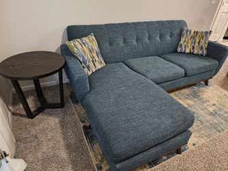 Blue Tufted Sectional Sofa, rug, and table