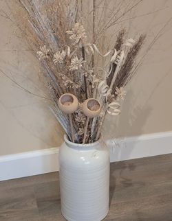 Large white ceramic vase with flowers arrangement