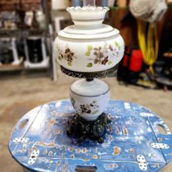 vintage milk glass hurricane lamp with hand-painted flowers and a brass base