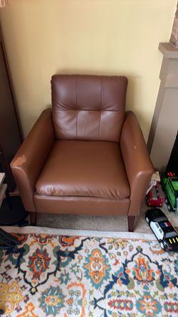 Brown faux leather accent chair.