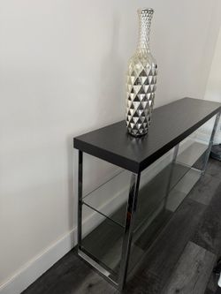 Modern console table dark brown wood-look top with a subtle grain pattern.