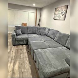 Gray Corduory sectional pull out sofa bed with USB charger on arm rest