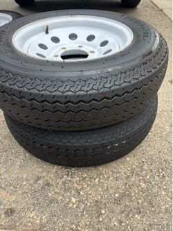 2 trailer wheels and tires