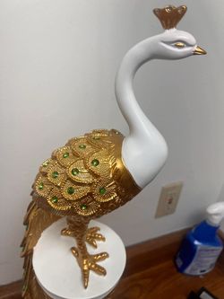 Resin peacock statue is the epitome of luxury, glowing with an exquisite mix of gold and emerald. Beautiful sculpture that gives any room a royal touc