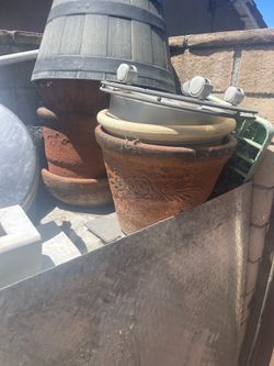 Terra-cotta pots, different size also vintage fireplace selling everything carrying out making an offer