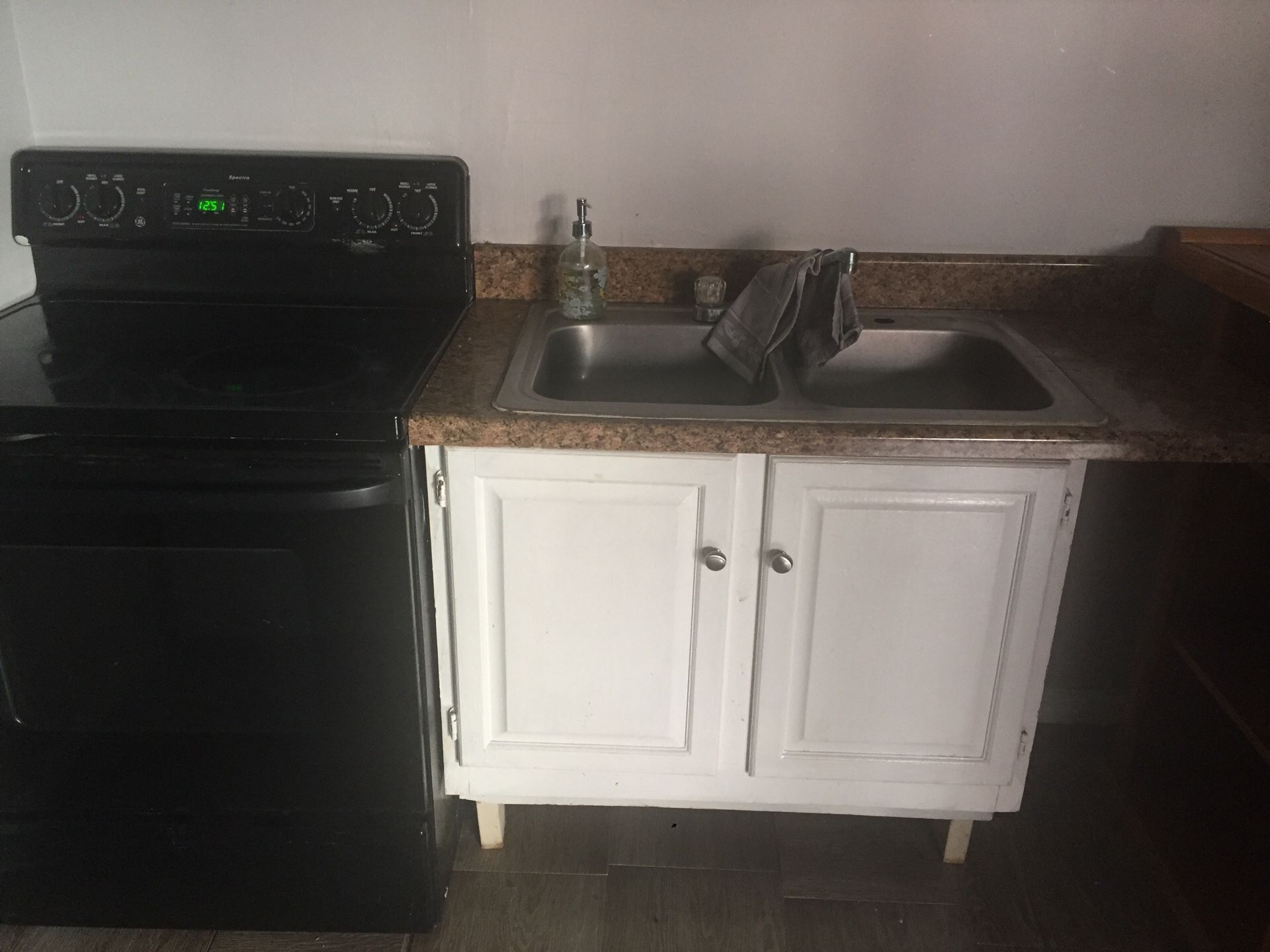 Cabinet sink and electric stove and countertop