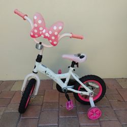 Preowned kids bicycle with training wheels ready to ride