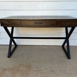 This is a modern industrial desk featuring a rustic wood top and a black metal base.