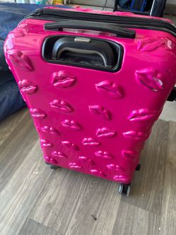Rare pink It girl rolling suitcase with raised smooch lips
