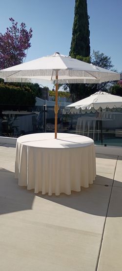 54" round tables, tablecloths, umbrellas, white wooden chairs