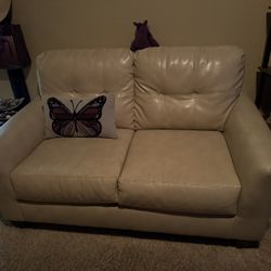 Cream faux leather love seat
