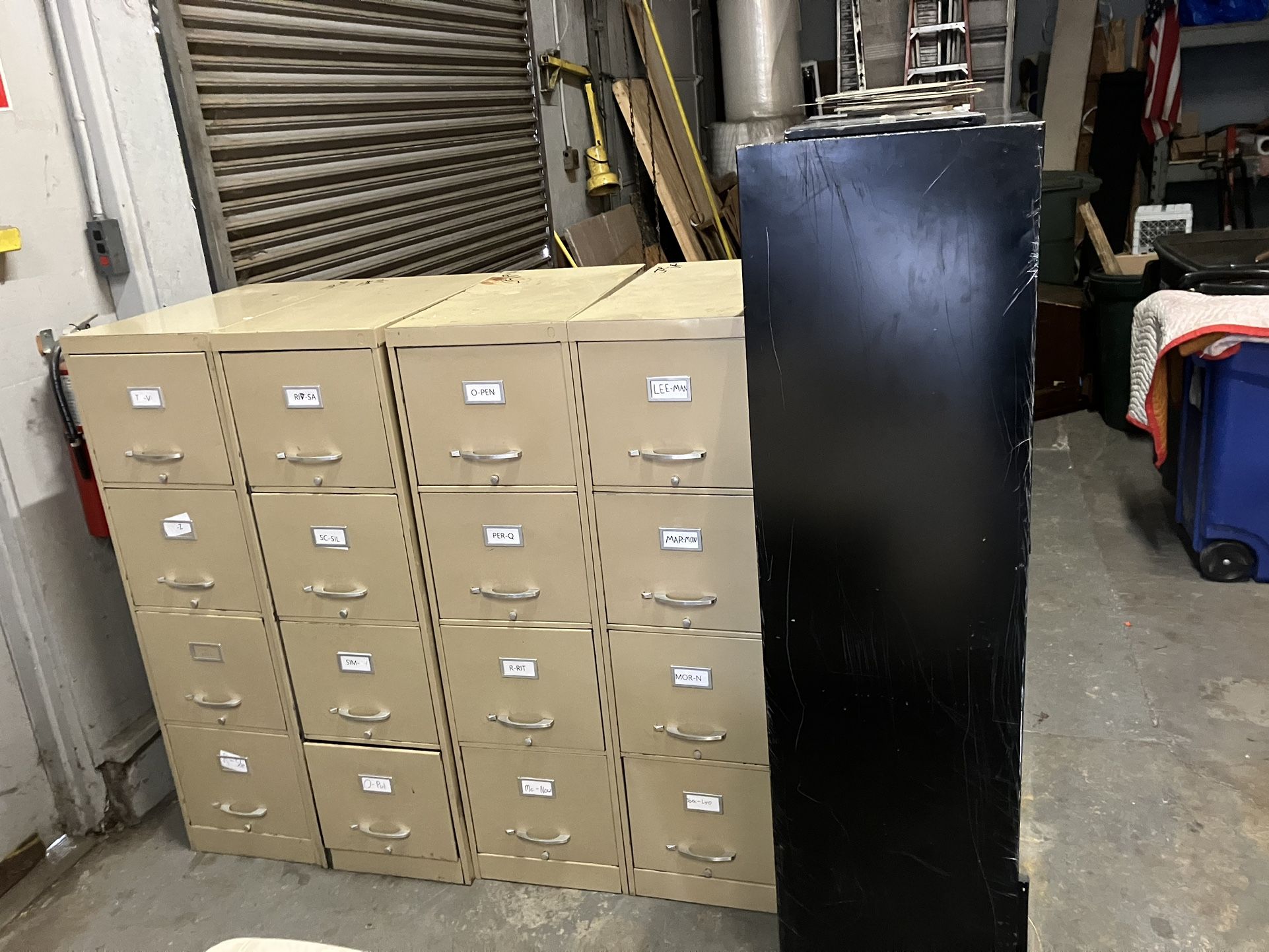 Four drawer file cabinets and large black legal file cabinet