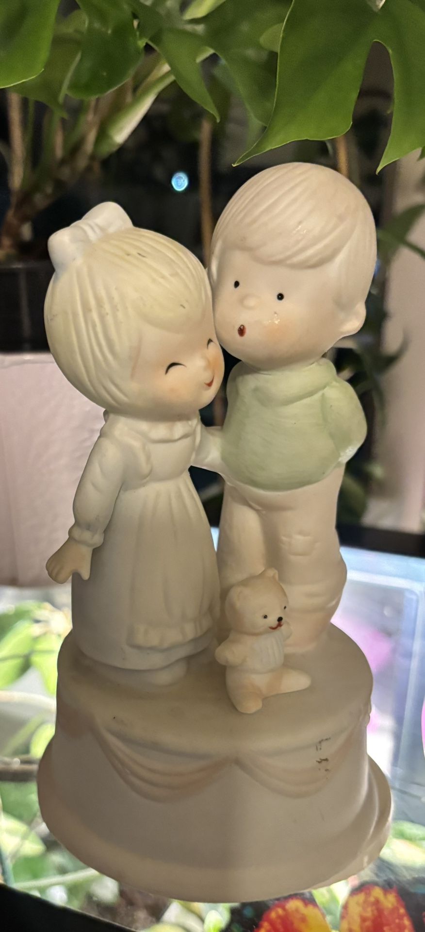 a small mechanically wind-up musical figurine that rotates around its axis