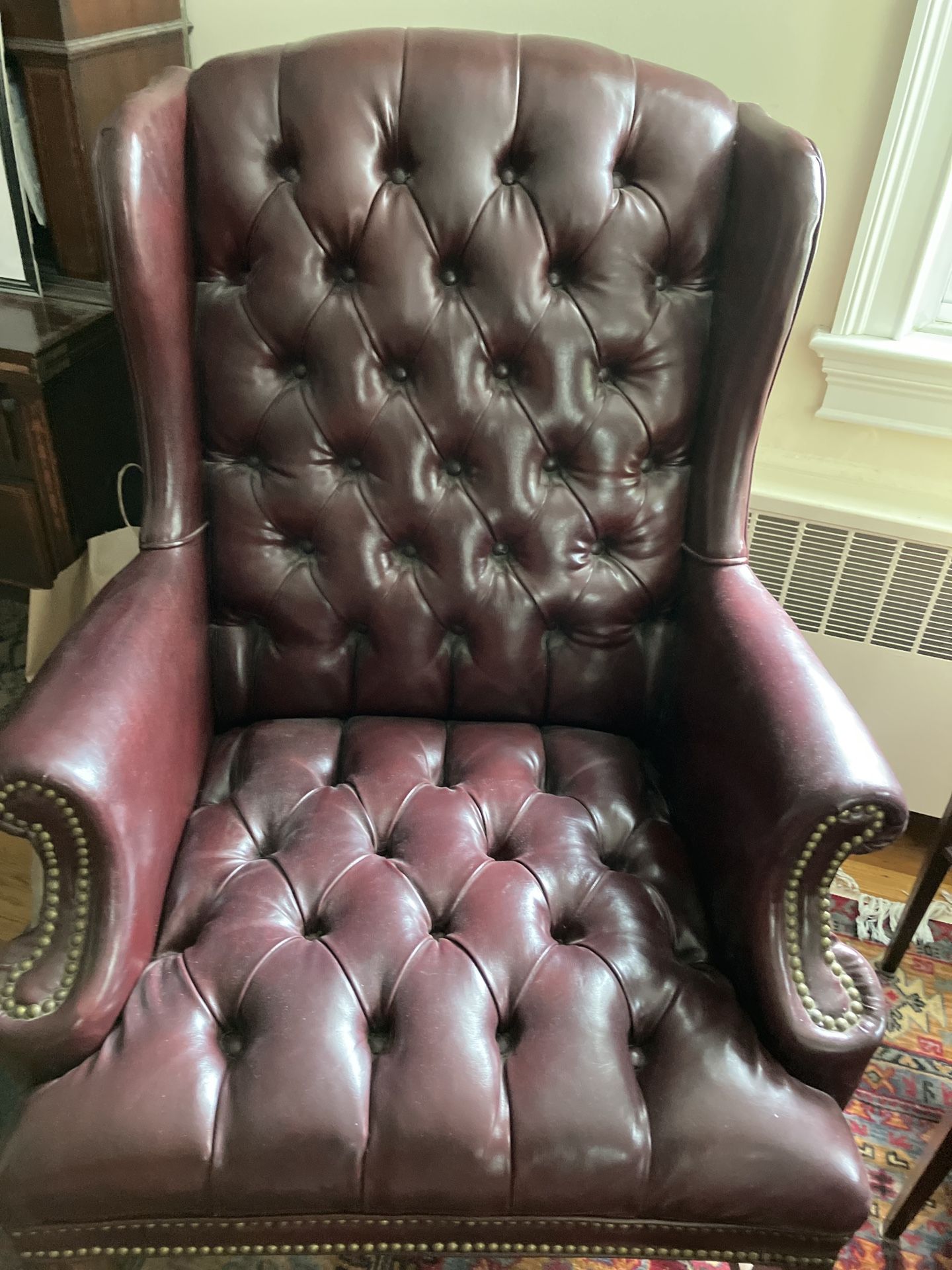 Leather wing back chair and ottoman great condition maroon