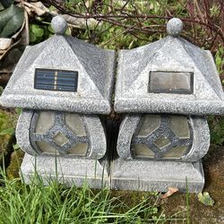 Pair of stone look solar garden lanterns . Read Description