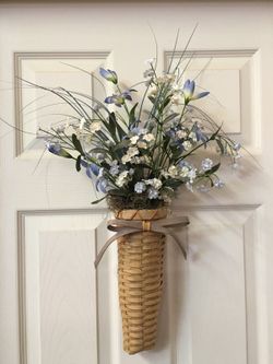 Blue and white floral in whicker vase handing arrangement