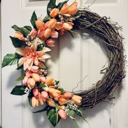 Wreath for front door 22” New. Faux silk peach color tulips. Ships in its own box. Cones from a smoke free environment.  