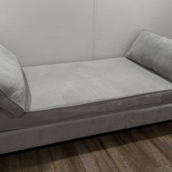 Living Spaces Grey Couch With Two Pillows