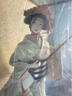 Japanese porcelain doll on glass display case