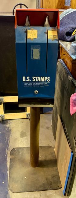 Vintage US Postal Service stamp machine with stamp stamps