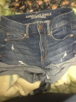 American eagle shorts and Jean skirt and a black top with flowers zipp up in the front